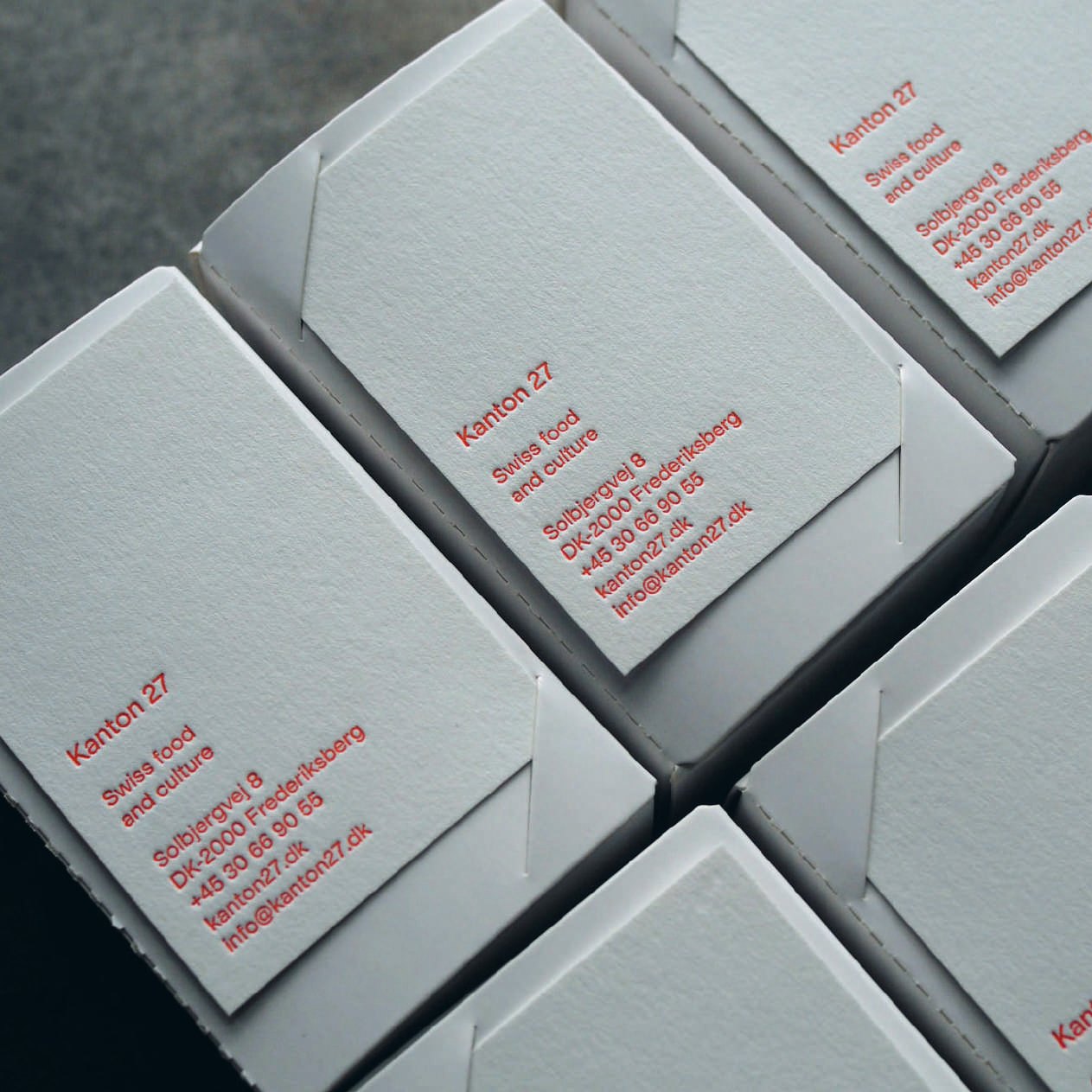 Business cards letterpressed in red, boxed