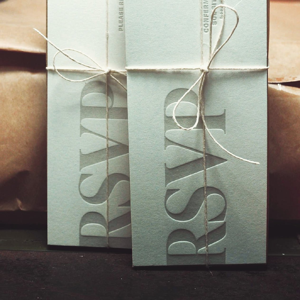 Debossed RSVP cards tied with string