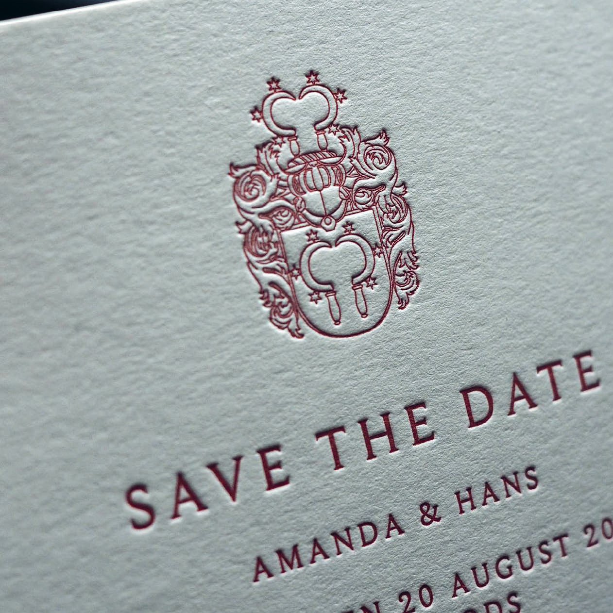 Save the date card with a red crest, letterpressed